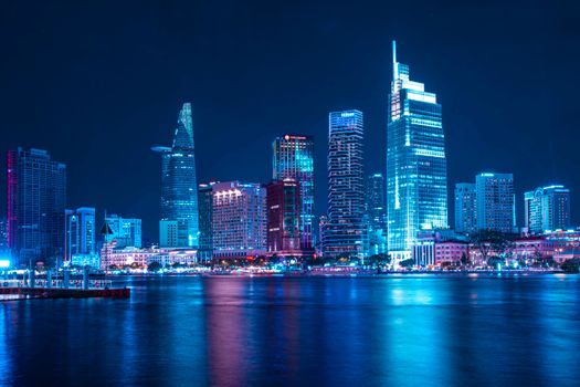 Stunning view of Ho Chi Minh City skyline with vibrant lights reflecting on the water.