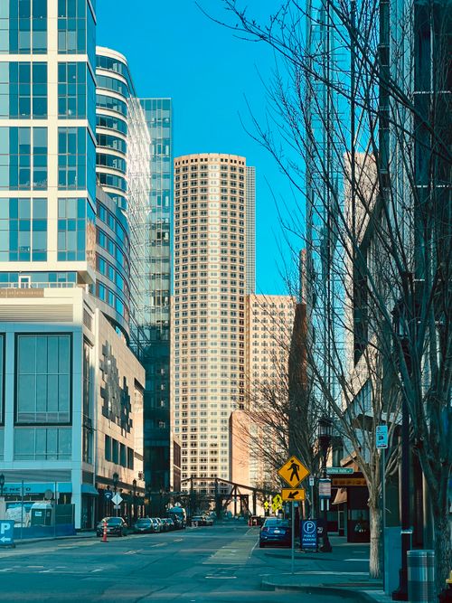 Free City street view featuring modern skyscrapers and clear blue sky. Stock Photo