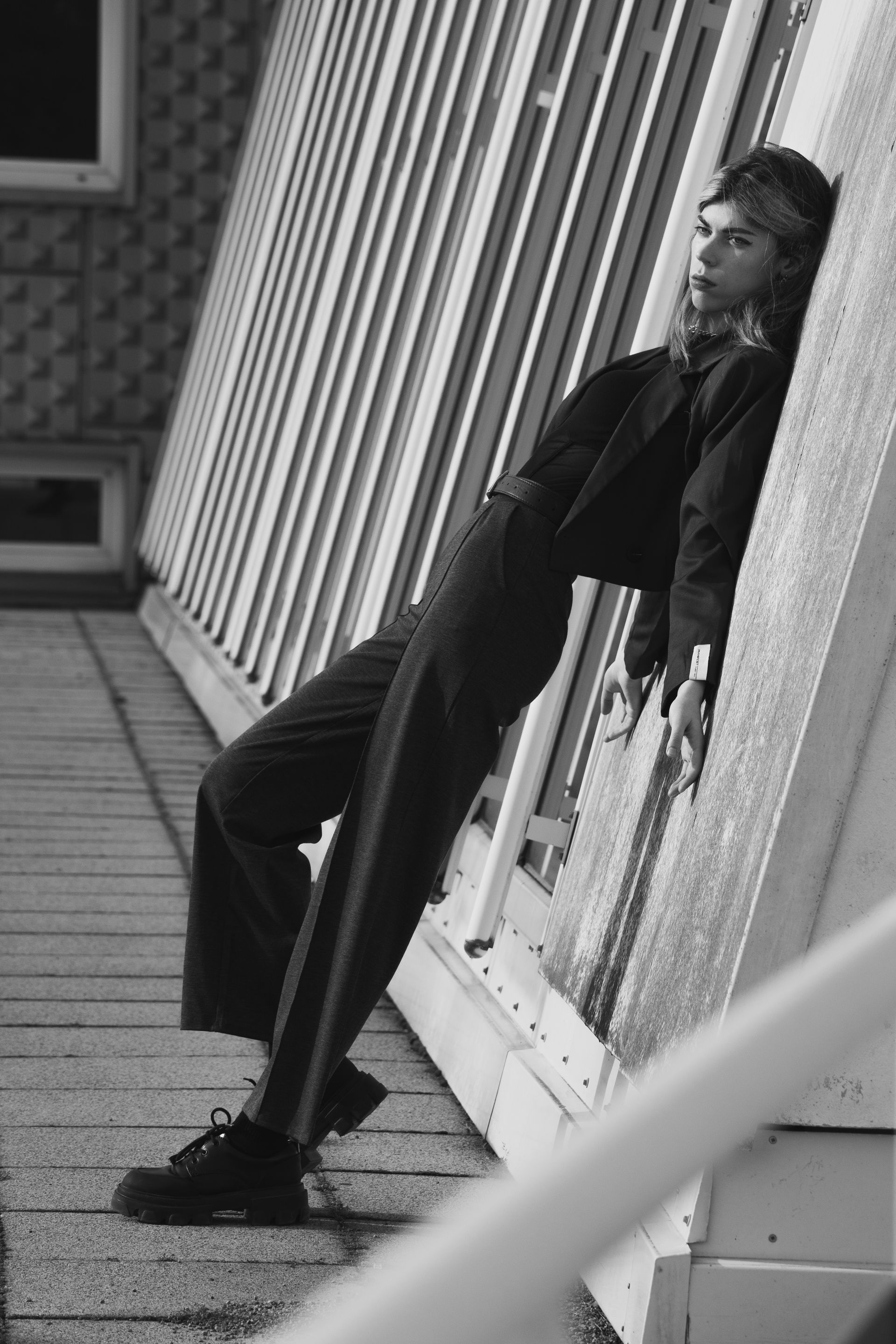 Chic Model Leaning Against Modern Architecture · Free Stock Photo