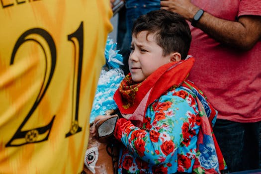 Child in vibrant clothing among street festivities in Tultepec, Mexico.