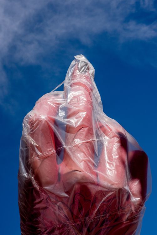 Red Object Wrapped in Plastic Against Blue Sky · Free Stock Photo