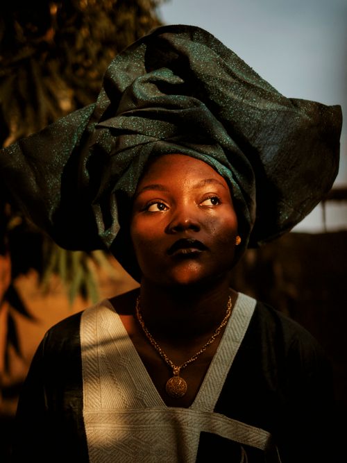 Free A striking portrait of a woman wearing traditional African clothing with headwrap. Stock Photo