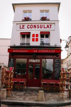 Front view of Le Consulat café in Montmartre, Paris, showcasing iconic Parisian charm.