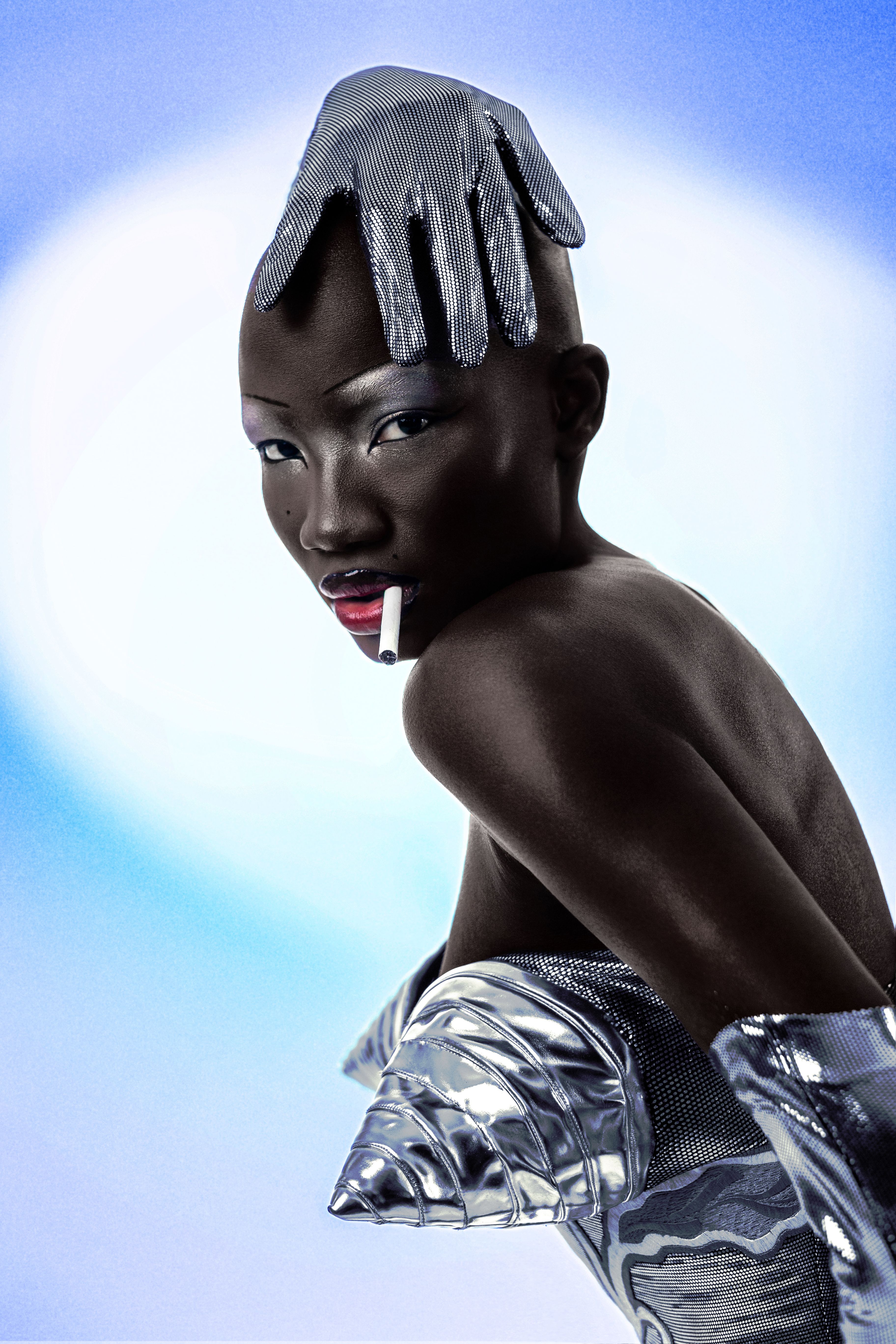 Striking portrait featuring futuristic metallic fashion and bold makeup, capturing a unique and artistic style.