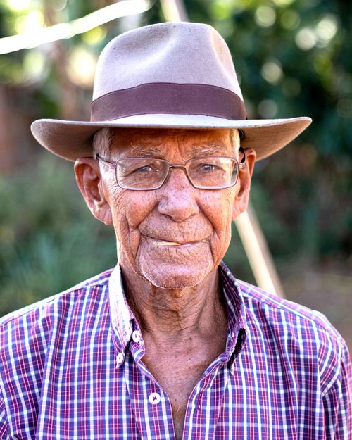 Free Close-up portrait of a senior man outdoors wearing a cowboy hat and plaid shirt. Stock Photo