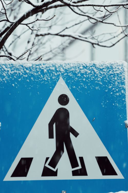 Free A pedestrian crossing sign covered with snow in Tromsø, Norway. Stock Photo