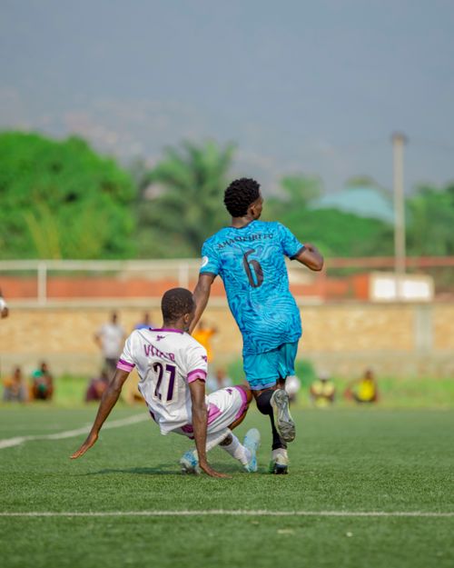 Free Action-packed soccer match between two athletes on a vibrant outdoor field. Stock Photo