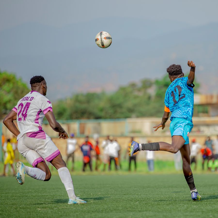 Two players contesting a loose ball during a match.