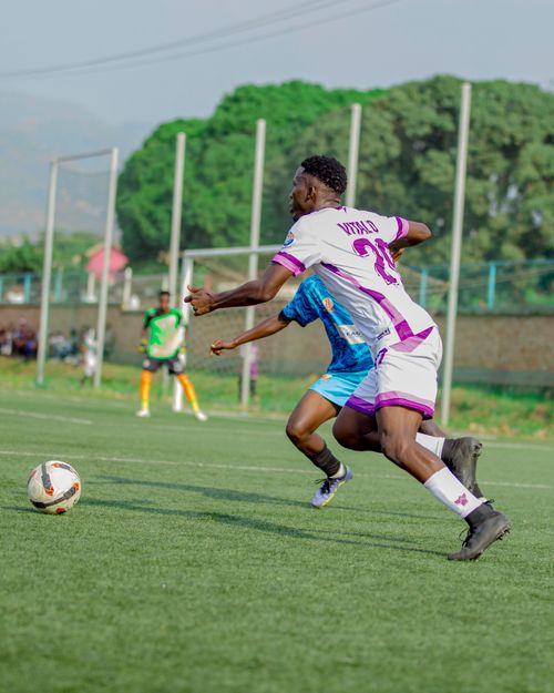 Free Soccer players in action during a match on a green field, showcasing competitive sports spirit. Stock Photo