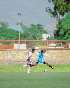 Two soccer players sprinting on a field in a competitive match outdoors.