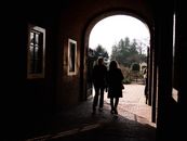 Silhouettes of two women walking through a sunlit archway in Leiden, Netherlands.
