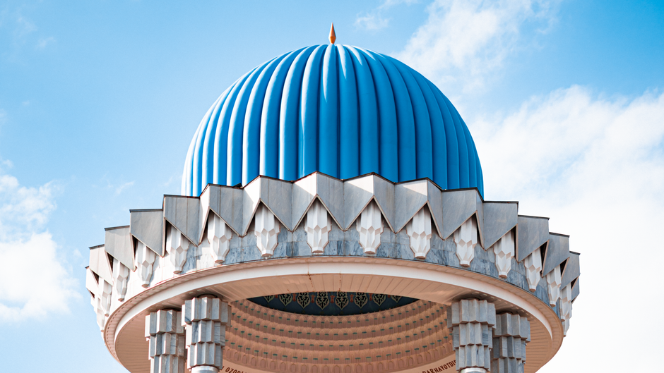 Explore the unique architecture of Tashkent's iconic dome against a bright sky.