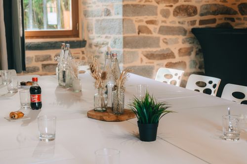 Free A modern indoor meeting table setup with refreshments in a cozy stone-walled room. Stock Photo