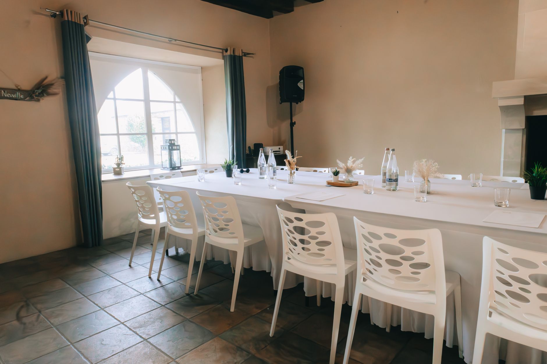 Bright and classy conference room setup with elegant chairs and table, lit by natural daylight.