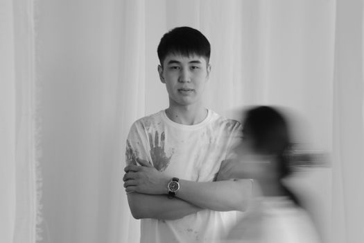 Black and white portrait of a man with motion blur, creating a dynamic effect.