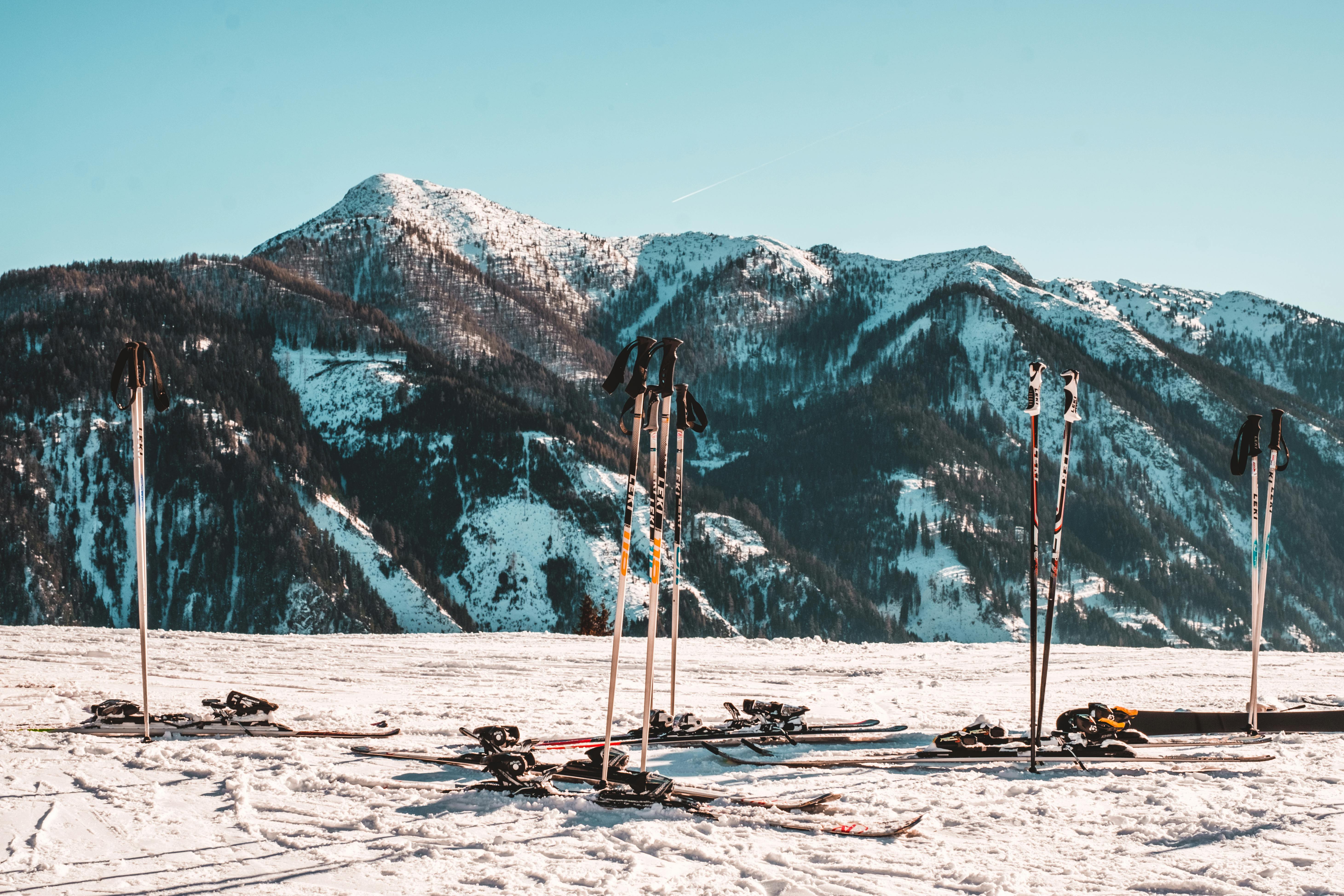 Prescription Goggle Inserts - Skiing gear on a snowy slope with Austrian Alps in the background, capturing a serene winter scene.