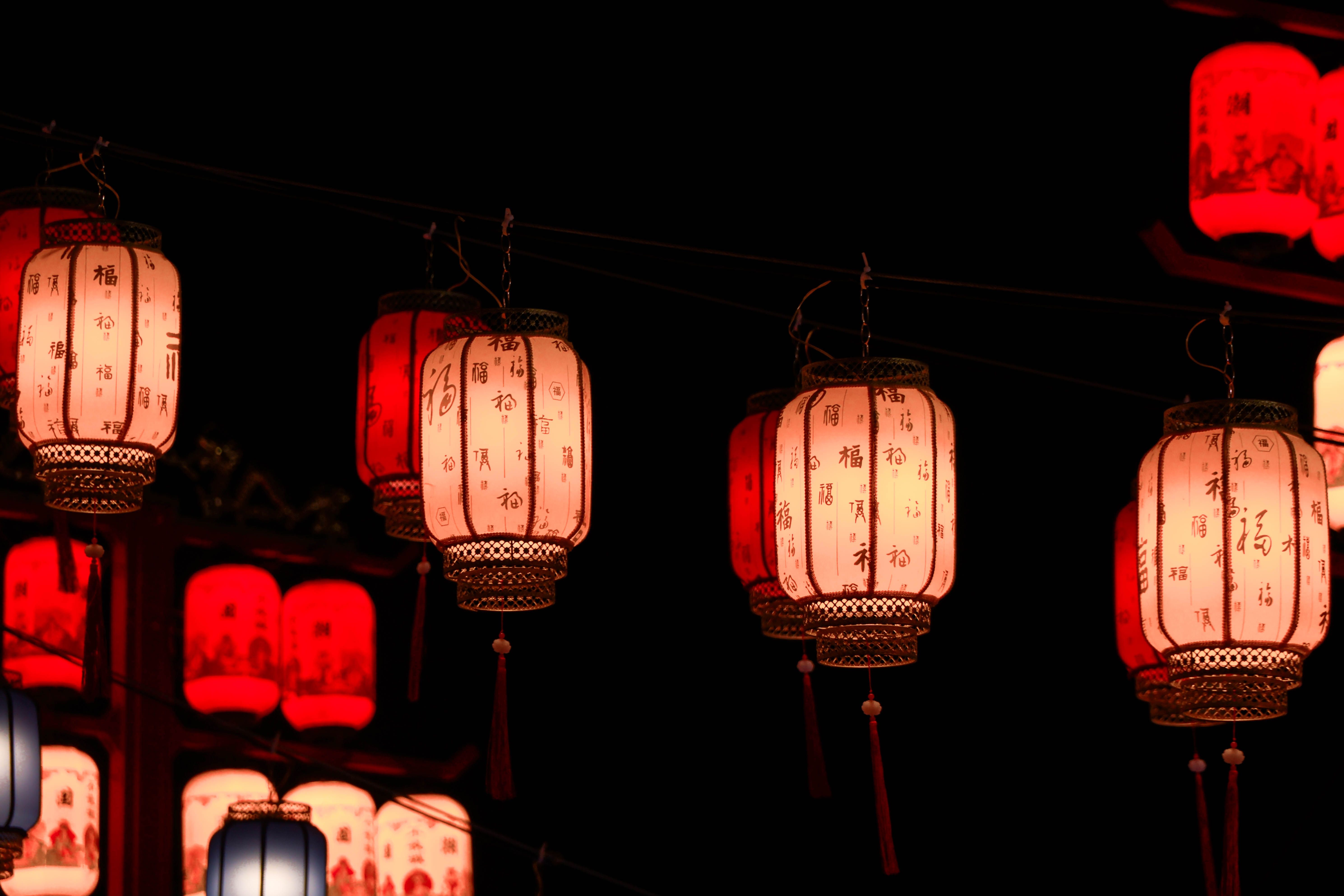 Glowing red lanterns illuminate the night, capturing the essence of a traditional Chinese festival celebration.