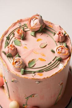 Beautifully decorated pink floral cake with buttercream roses and delicate designs.