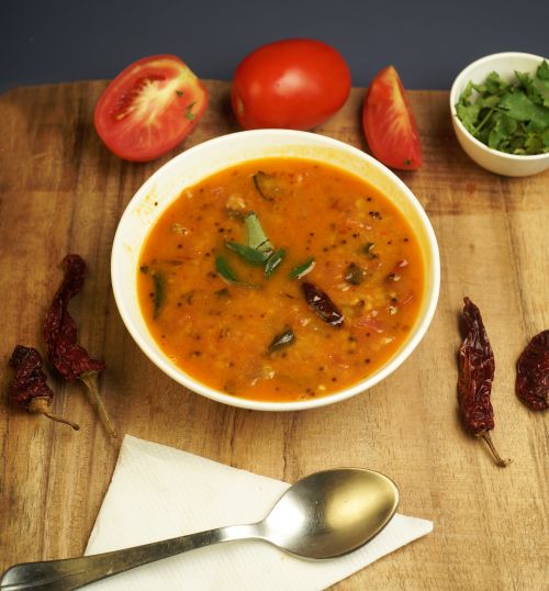 Free A hearty tomato soup garnished with spices and cilantro, perfect for a cozy meal. Stock Photo
