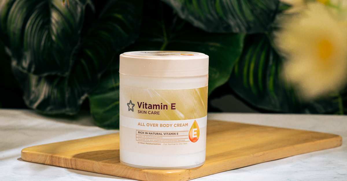 Vitamin E skincare cream on wooden tray with botanical background. - Evidence evidence guide for vitamin E skin health meta-analysis