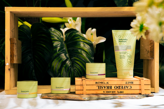 Skincare products showcased among lush greenery with a natural radiant theme.