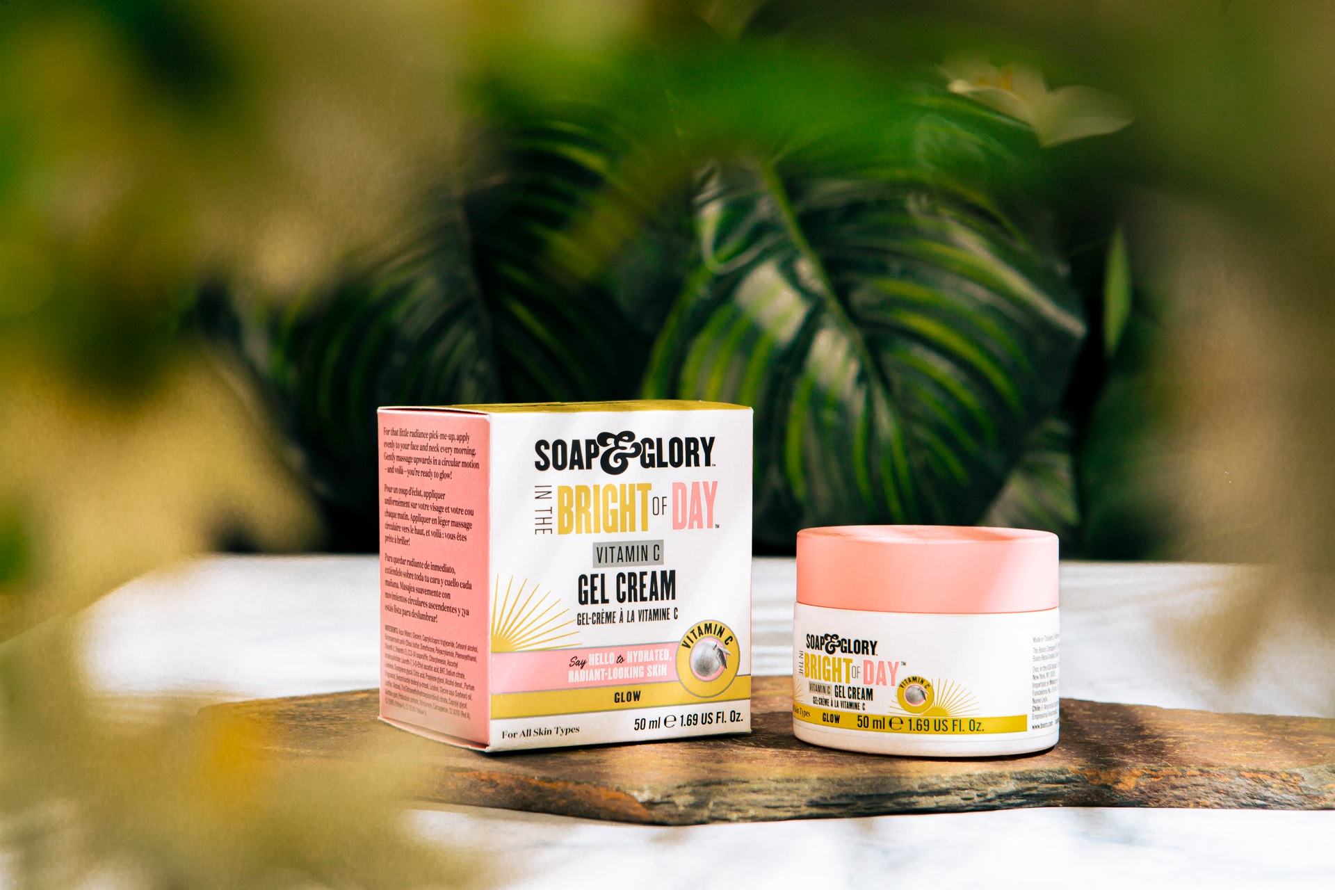 Bright of Day vitamin C gel cream on display with lush green backdrop for radiant skin care.