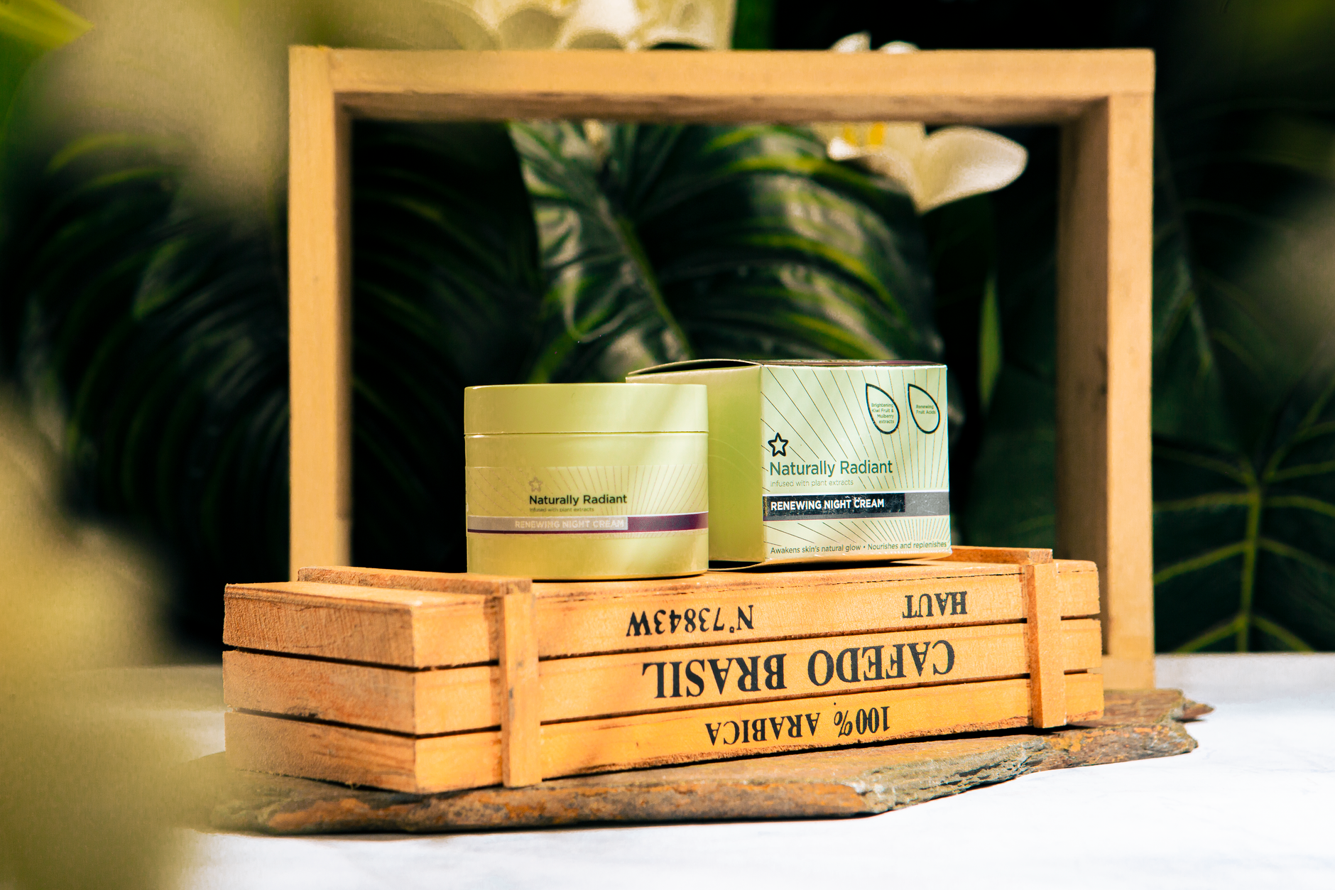 Elegant display of Naturally Radiant night cream in a wooden frame setting.