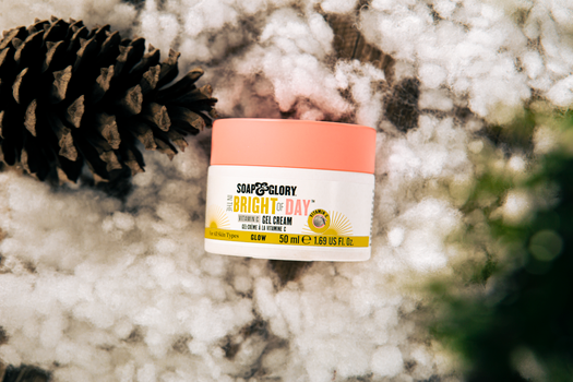 Soap & Glory Bright of Day Gel Cream with Vitamin C displayed with snow and pinecones.
