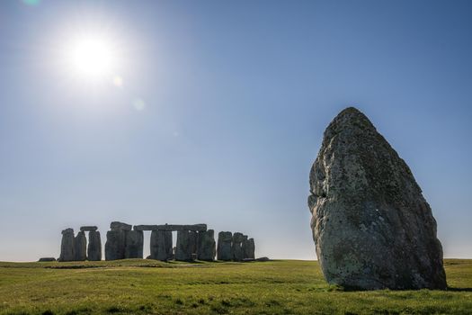 Stonehenge landscape captured under the bright midday sun on a clear day.