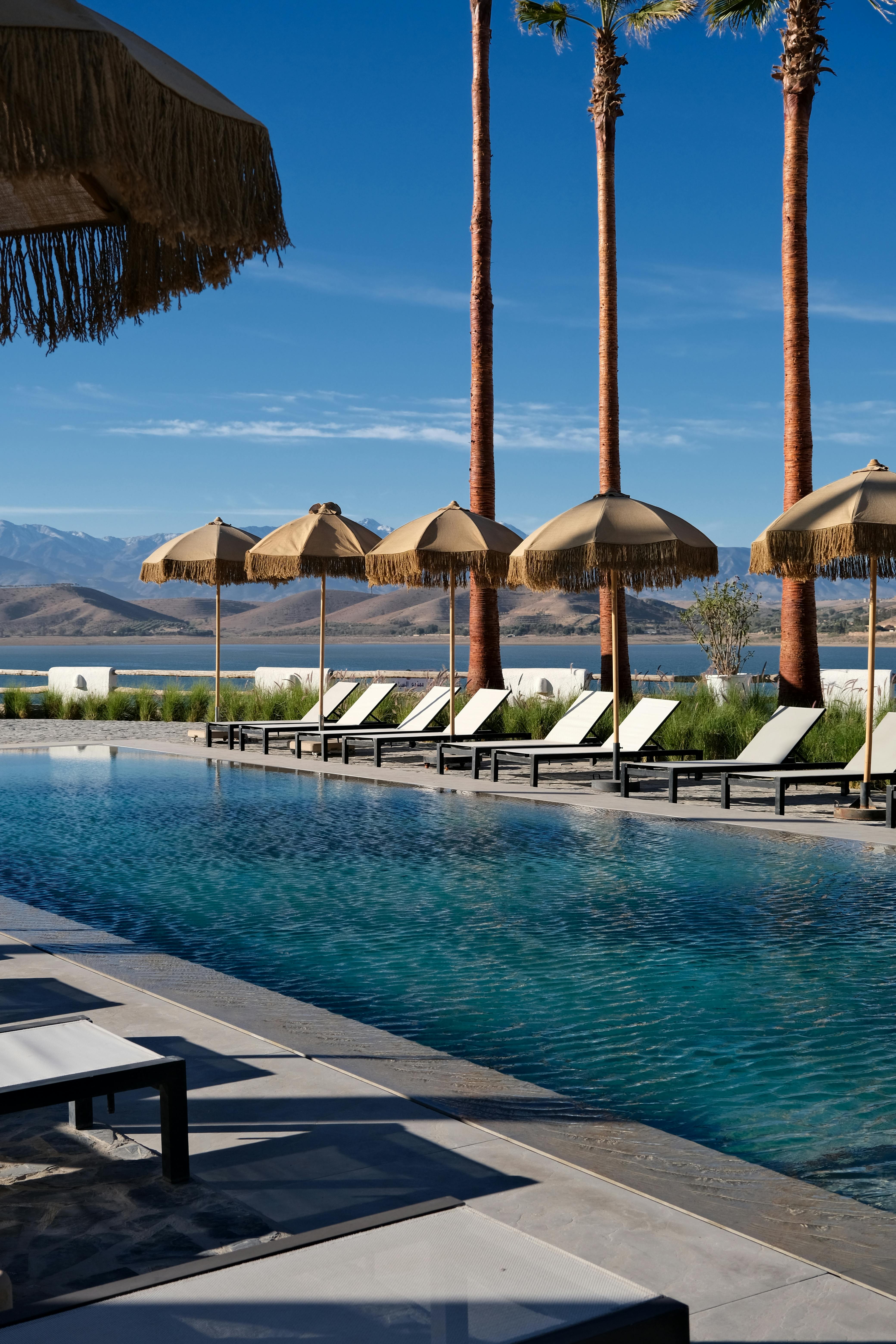 Serene poolside view with loungers and umbrellas, Aguergour, Morocco.
