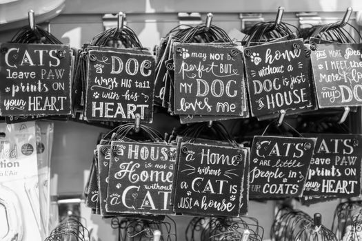 Monochrome image of various pet-themed quote signs, perfect for animal lovers.
