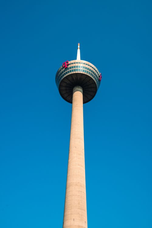 Free The Cologne Telecommunication Tower with a minimalistic blue sky background, showcasing architectural design. Stock Photo
