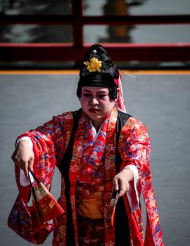 Traditional Japanese performer in vibrant attire at Buenos Aires cultural event.
