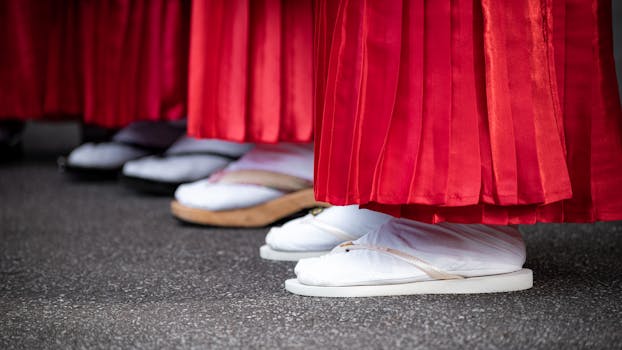 Close-up of traditional Japanese footwear and red attire in cultural setting, Buenos Aires.