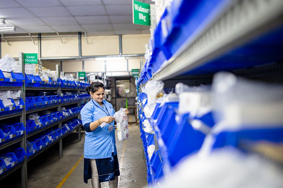 Warehouse worker organizing shelves in a distribution center