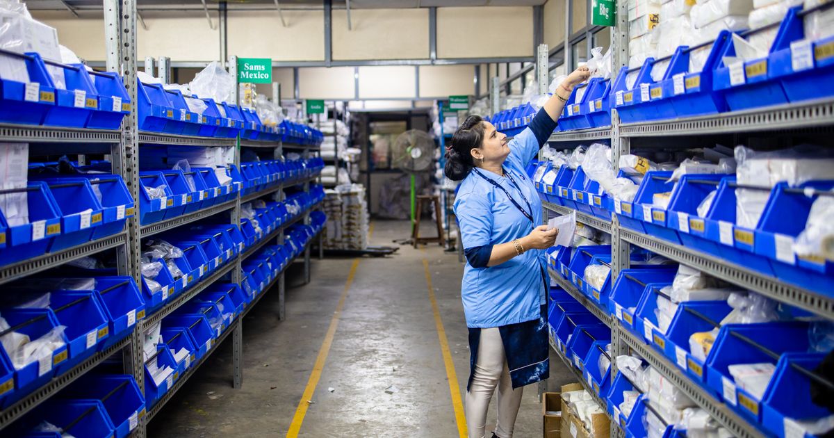 Worker organizing inventory on warehouse shelves
