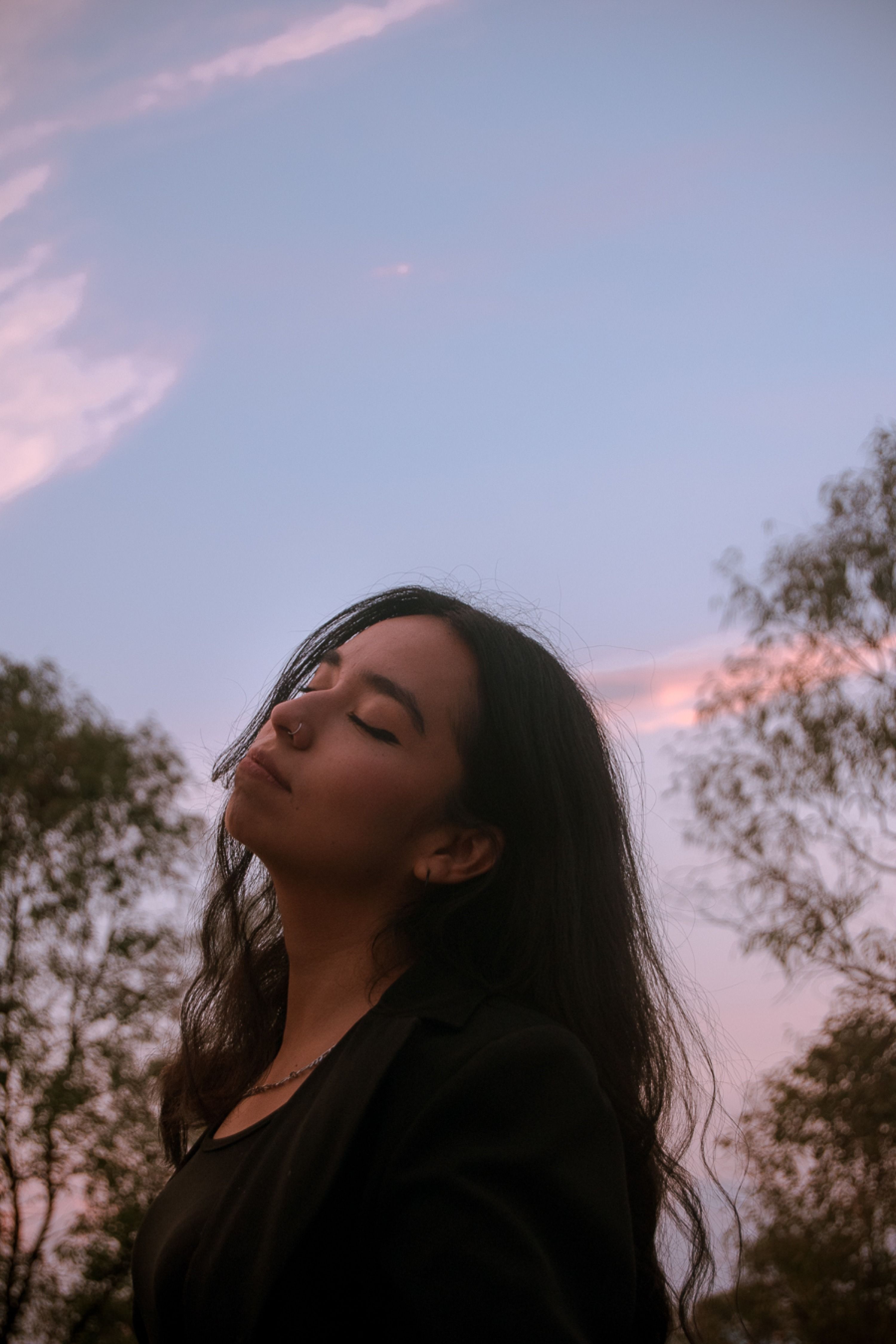 Contemplative Woman at Sunset Outdoors · Free Stock Photo