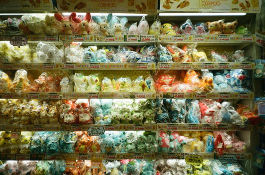Vibrant collection of assorted plush toys packaged neatly on store shelves.