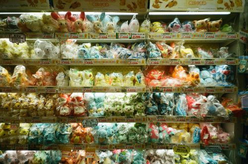 Free Vibrant collection of assorted plush toys packaged neatly on store shelves. Stock Photo