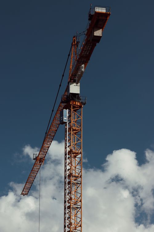 Free A construction crane against a cloudy sky in Gothenburg, Sweden. Stock Photo
