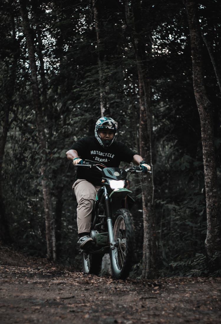 Man Riding Dirt Bike Near Trees