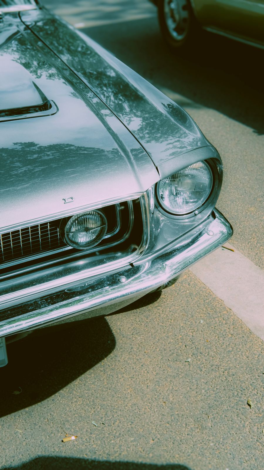 A classic Ford Mustang parked on a sunny street