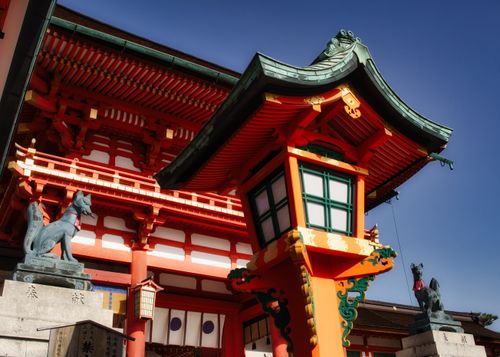 Free Vibrant architectural details and fox statues at Fushimi Inari Shrine, Kyoto, Japan. Stock Photo