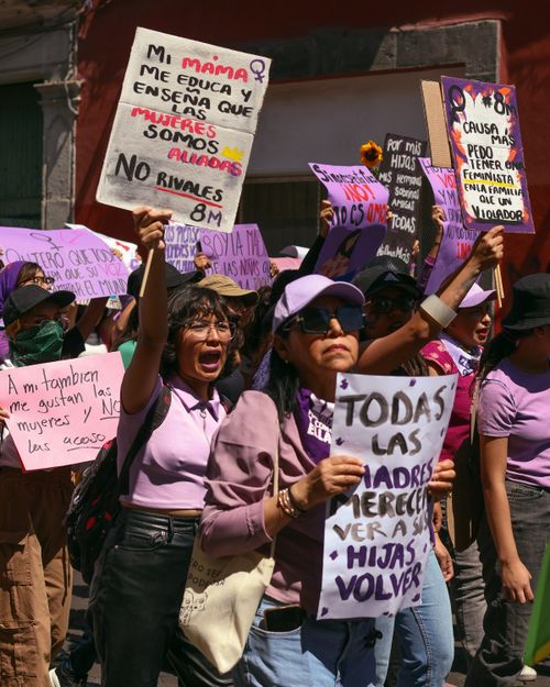 Free Women advocating for rights with motivational protest signs during a march. Stock Photo