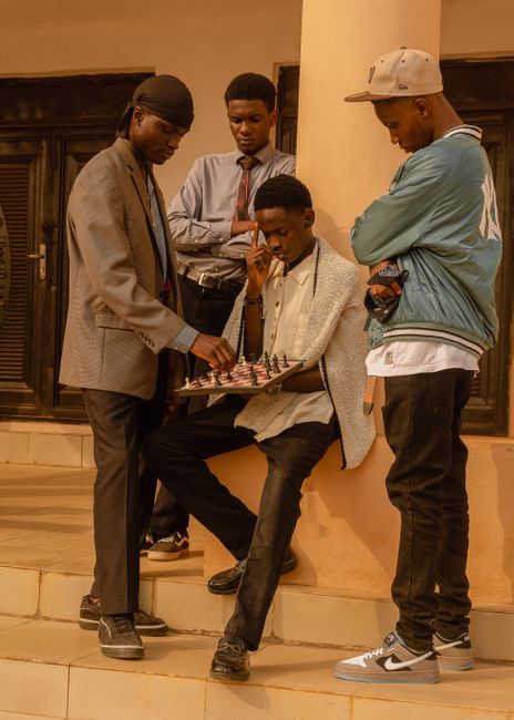 Group of young men playing chess on the steps in Ado Ekiti, Nigeria.