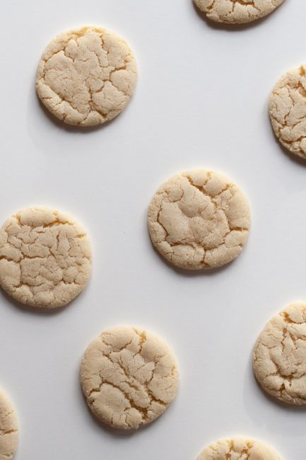 Flat lay of sugar cookies arranged on a white surface, perfect for baking themes.