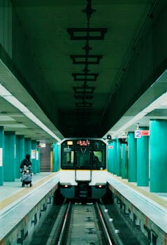 A subway train approaches a platform in a Tokyo station. Shows urban transit system.