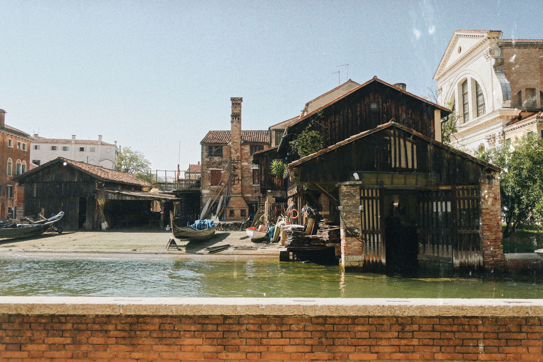 Rustic gondola workshop on a sunny day in Venice, Italy.