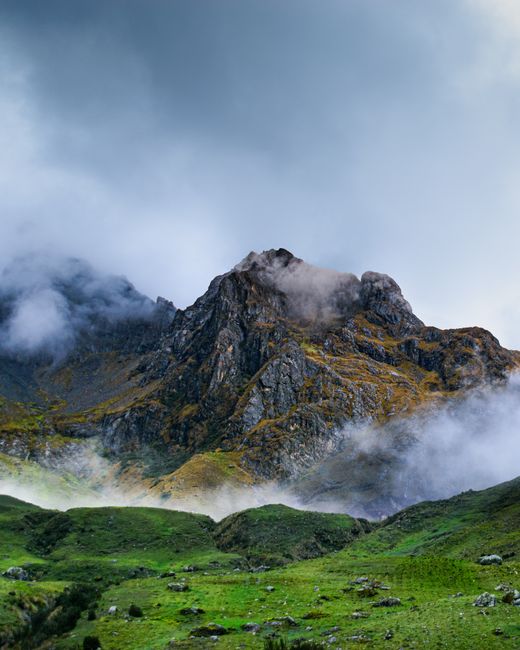 Stunning view of the Andes Mountains in Ollantaytambo, Peru, shrouded in mist.