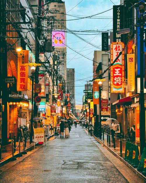 Free Vibrant urban scene in Japan at dusk with colorful signage and local culture. Stock Photo